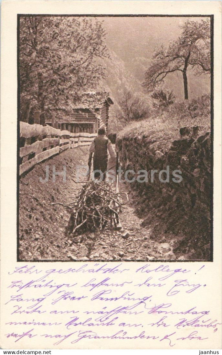 Heimat - man dragging bundle of firewood along village path - Series - 2170 - old postcard - Switzerland - used - JH Postcards