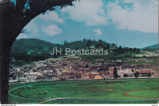 A view of Ooty Town with the Race course in the foreground - India - used - JH Postcards